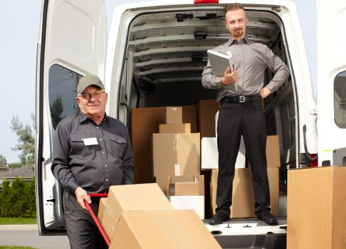 Packed moving boxes and furniture ready for transport in Ruislip