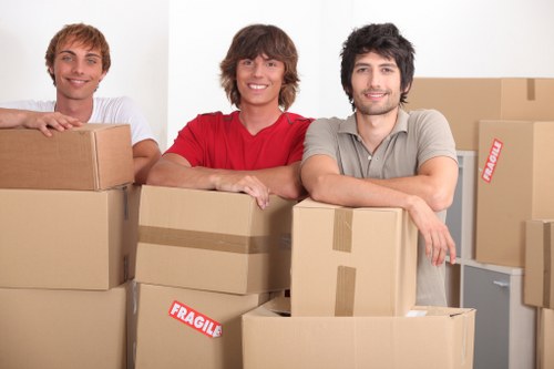 Trained removals staff using PPE while handling furniture